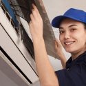 Female HVAC technician repairing an air conditioning unit, showcasing expertise for Jerry Brittingham A/C & Heat, Inc.