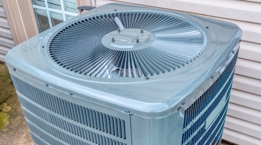 Exterior air conditioning unit and signs of AC replacement needed.
